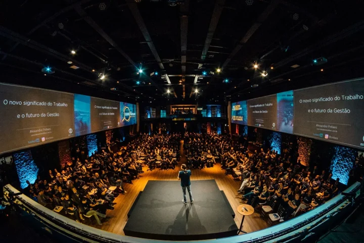 Speaker on stage in front of a large audience