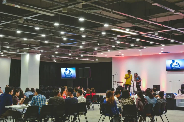 Participants seated at tables in a large seminar room