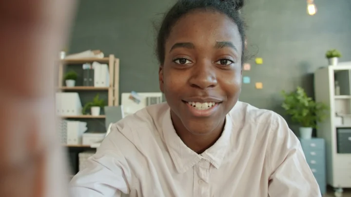 Jeune femme souriante face caméra dans un bureau