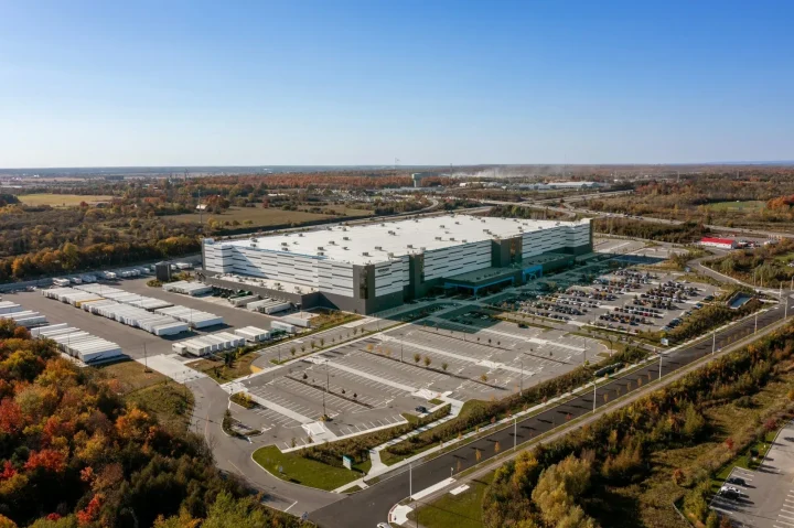 Aerial view of a large logistics building and its car park