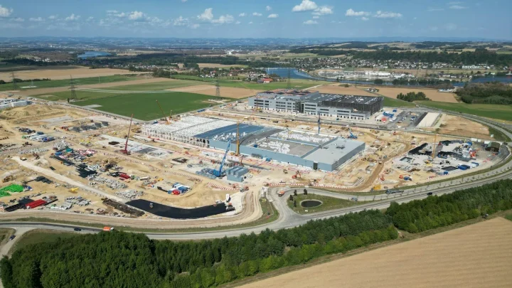 Aerial view of a large construction site with cranes and buildings